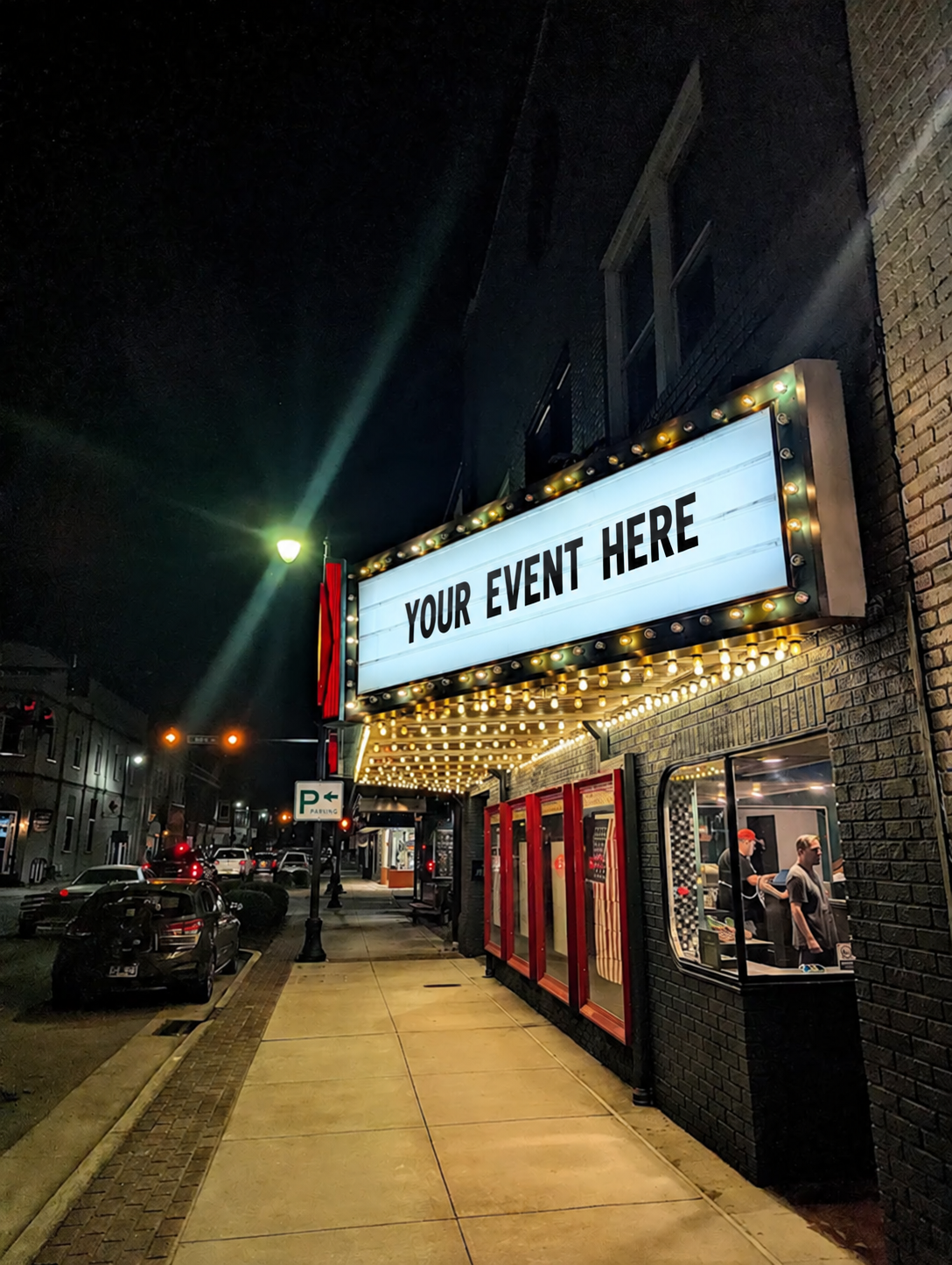 Capitol Hall marquee glowing above the downtown Erwin sidewalk